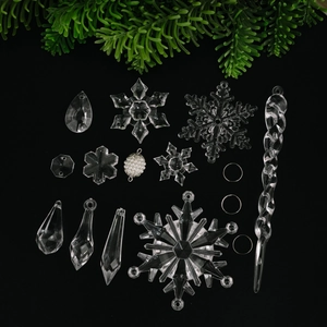 Clear acrylic snowflake and icicle Christmas tree ornaments set on a black background