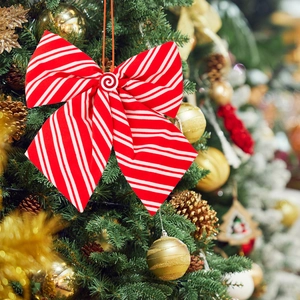 Christmas tree ornament featuring a red and white striped bow with candy spiral button