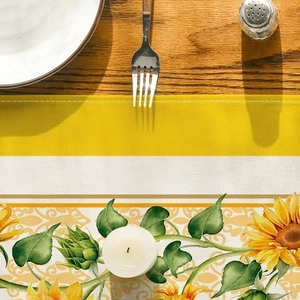 Detail of yellow sunflower prints and fabric texture on a striped cotton linen table runner