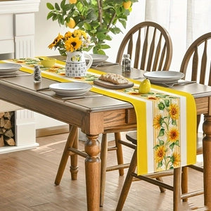 Detail of sunflower table runner with bright yellow borders on a dark wood dining table