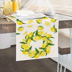 Linen table runner with summer lemon patterns and leaf wreaths on a dark wood table