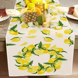 Summer table runner with lemon and green leaf pattern on a wooden dining table