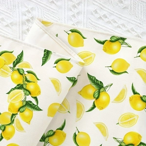 Detail of lemon pattern print on textured fabric runner with fine stitching edges