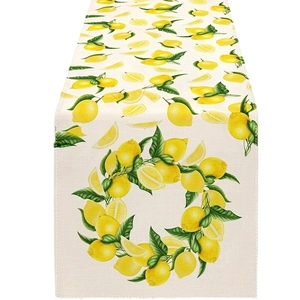 Summer table runner featuring lemon and green leaf patterns on textured linen fabric