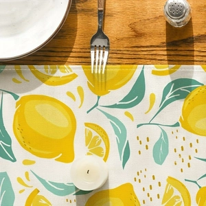 Close-up of lemon pattern table runner with cotton linen texture on wooden table