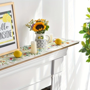 Close-up of rectangular table runner with vibrant lemon and wildflower patterns on white