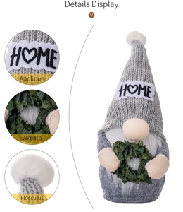 Close-up of a Christmas gnome with HOME letter applique and green leaf wreath detail