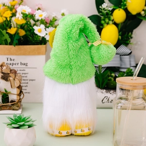Detail of summer lemon gnome plush with green fuzzy hat and yellow checkered bow decor