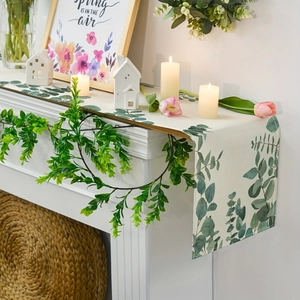 Eucalyptus leaf table runner on white fireplace with minimalist spring decor accents