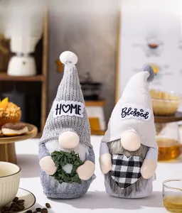 Detail of Christmas gnomes holding a green wreath and heart for home holiday decor