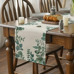 Minimalist eucalyptus leaf table runner on a wooden dining table for home decor