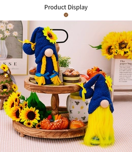 Detail of sunflower themed gnome plush set with blue knitted hats on a wooden tray