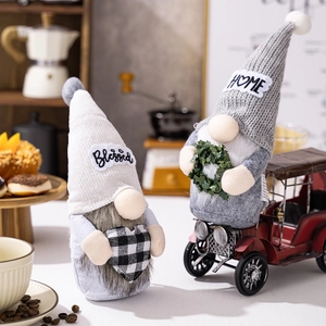 Close-up of handmade Christmas gnomes with Blessed and Home embroidery on cozy backgrounds