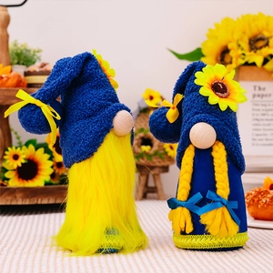 Close-up of spring sunflower gnomes with blue plush hats and golden braids or beard