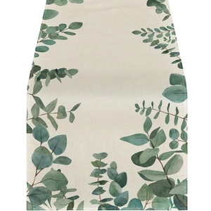 Minimalist table runner with green eucalyptus leaf pattern on cream linen fabric