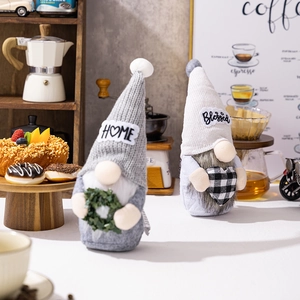 Close-up of Nordic Christmas gnomes with knitted hats featuring HOME and Blessed text