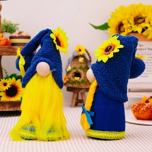 Detailed view of handmade sunflower gnome plushies in navy blue and bright yellow colors