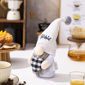 Close-up of a blue gnome plush with Blessed embroidery and a checkered heart decor