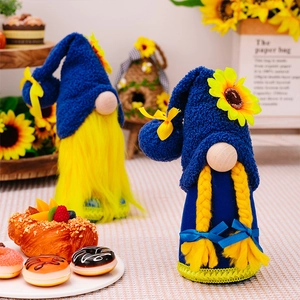 Macro shot of blue spring sunflower gnomes with yellow braided hair and knitted hats