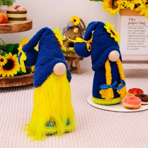 Close-up of spring sunflower gnomes with blue hats and bright yellow plush details