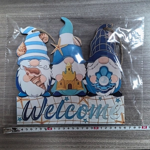 Detail of wooden ocean gnome welcome sign showing 25cm width measurement with starfish
