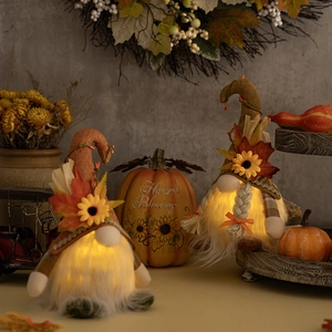 Lighted Thanksgiving gnomes with autumn maple leaves and sunflowers for harvest home decor