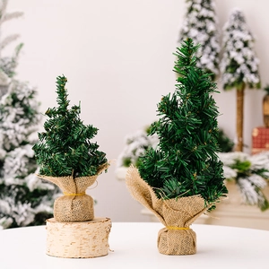 Pair of mini tabletop Christmas trees with burlap bases and natural wood slice decor