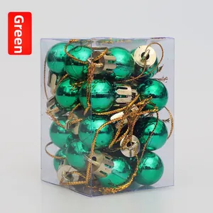 Detail of 2cm green Christmas ball ornaments with gold caps in a transparent box