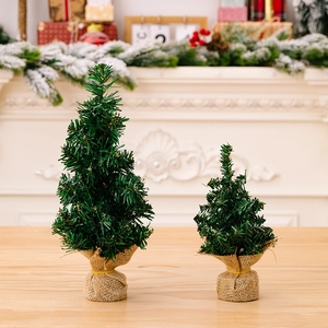 Set of two mini artificial Christmas trees with burlap bases for festive tabletop decor