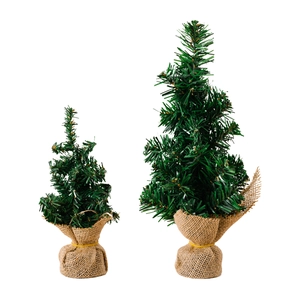 Two mini artificial Christmas trees with pine needles and rustic burlap bases for decor