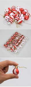Detailed view of mini red and white striped Christmas ornaments in bulk packaging