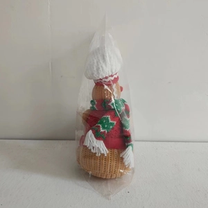 Detailed close-up of a knitted gingerbread man doll wearing a chef hat for Christmas decor
