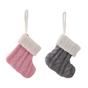 Pink and grey knitted Christmas stockings set with classic cable stitch design for tree decor