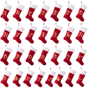 Red velvet personalized Christmas stockings with white faux fur cuff and gold letter embroidery