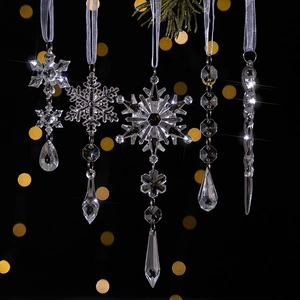 Detailed view of clear acrylic snowflake and icicle ornaments with silver ribbons