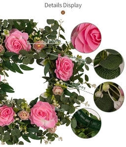 Detail display of pink camellia and eucalyptus wreath showing petals, leaves and base