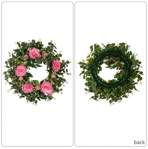 Detail showing the front and back of a pink camellia rose and eucalyptus leaf wreath