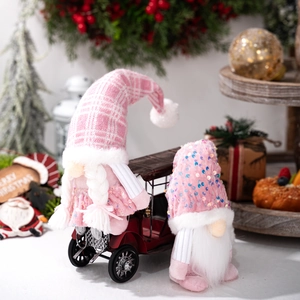 Pink Christmas gnomes with sequins and plaid hats on a vintage red truck decoration
