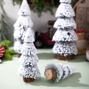 Miniature flocked Christmas tree with snow effect and natural wooden base for desk decor