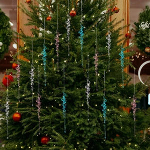 Christmas clear acrylic spiral icicle ornaments hanging on a decorated festive tree