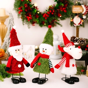 Three Christmas plush figurines with spring legs including Santa, snowman and reindeer