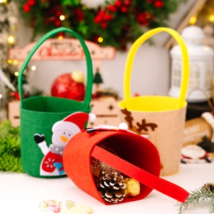 Three Christmas felt candy bags with snowman and reindeer designs for holiday gifting