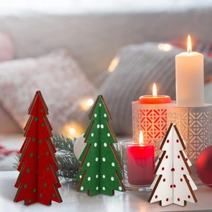 Three wooden Christmas tree desk ornaments in red green and white with polka dots