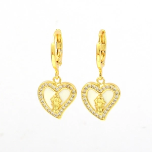 Macro shot of gold-plated heart earrings with virgin mary icon and cubic zirconia