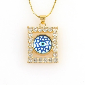 Macro shot of 18k gold rectangular evil eye pendant with micro-paved cubic zirconia