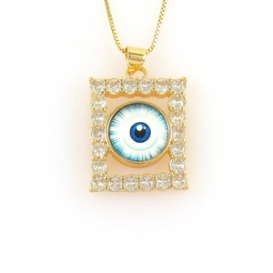 Detailed shot of 18k gold evil eye pendant with micro-inset zircons on a box chain