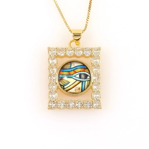 Close-up of gold Eye of Horus pendant with micro-pave cubic zirconia and colorful details