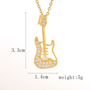 Macro view of crystal paved electric guitar pendant with 3.3cm size measurement detail