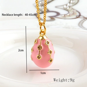 Detailed view of pink enamel Faberge-style egg pendant with gold-plated dimensions