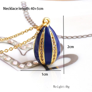 Macro detail of blue enamel drop pendant with gold plating and cubic zirconia inlay
